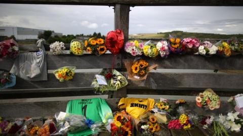 Floral tributes placed on a bridge over the river Adur near where the Hawker Hunter fighter jet crashed