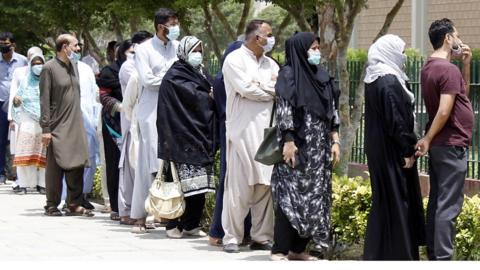 People line up for a coronavirus vaccination in Karachi, Pakistan