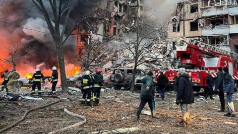 Rescuers and local residents are seen at a site of an apartment building heavily damaged by a Russian missile strike, amid Russia's attack on Ukraine, in Dnipro, Ukraine