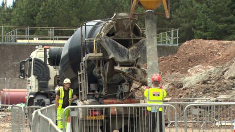 Builders working with a cement mixer