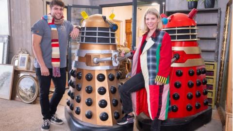 Two Daleks with staff wearing items due to be auctioned