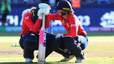 England's Sarah Glenn is comforted by team-mate Charlie Dean after they were beaten by South Africa