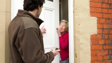 Pushy salesman trying to sell to older woman