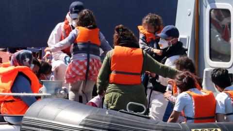 Border Force escorts a family off a boat