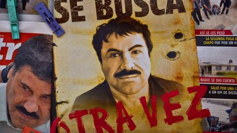 A poster of El Chapo saying "wanted again" in Spanish