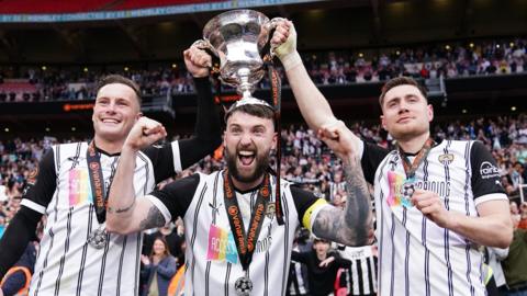 Notts County's Macaulay Langstaff (left), Kyle Cameron (centre) and Cedwyn Scott celebrate with the trophy after the Vanarama National League play-off final at Wembley Stadium