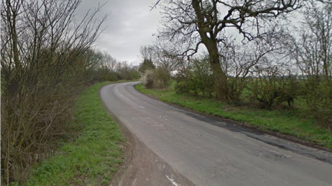 A view looking up Pennyhill Lane in South Yorkshire, with trees lining the road