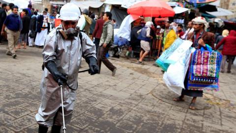 Worker disinfects pavement in the old city market in Sanaa (30/04/20)