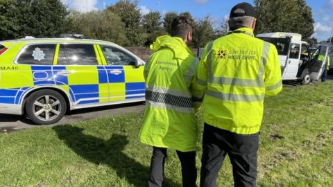 Environment and police officers checking a stopped vehicle