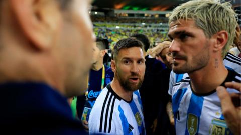 Lionel Messi attempting to calm the sitaution down after trouble broke out before Argentina's match against Brazil