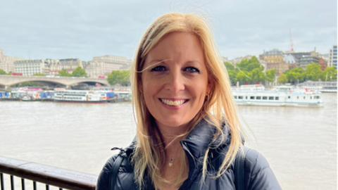 A woman queueing by the River Thames