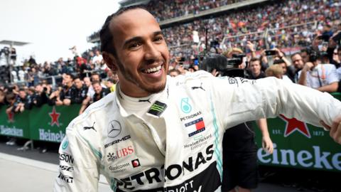 Mercedes driver Lewis Hamilton celebrates after winning the 2019 Chinese Grand Prix