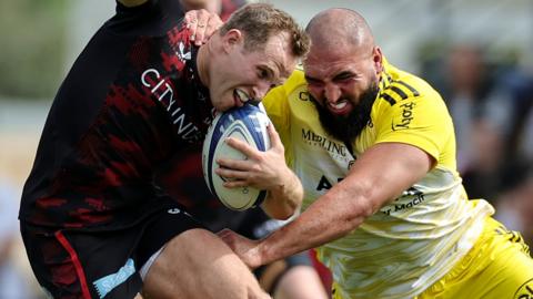 Max Malins of Saracens is tackled by a La Rochelle player