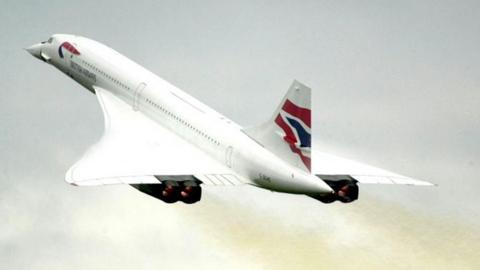 Concorde, a plane with large wings, flies through the air.