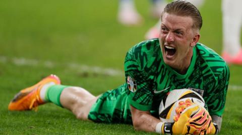 Jordan Pickford holds on to the ball during England's victory over Slovakia