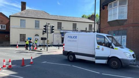 A police vehicle near a cordon