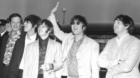The Beatles and Brian Epstein (far left) arrive back in London in 1966 after their ill-fated tout of Asia