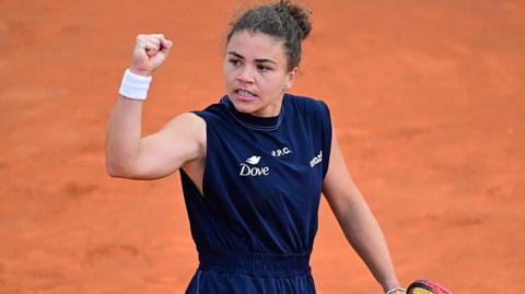 Jasmine Paolini raises her fist in celebration