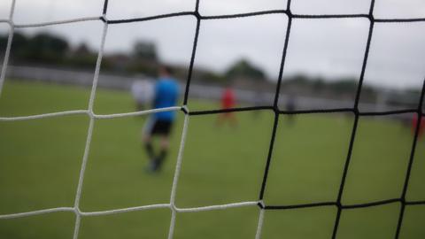 A stock photo of a black and white football net.