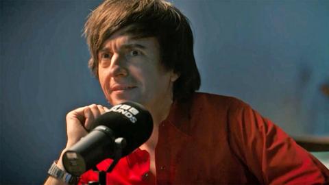 Danny Robins wearing a red shirt 