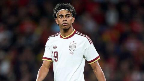 Lamine Yamal wearing a white Spain shirt