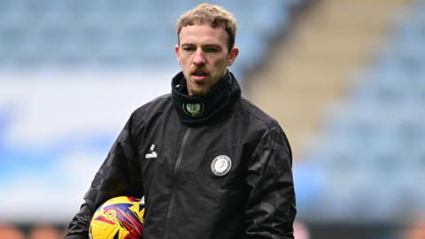 Lewis Thomas during a pre-match training session 