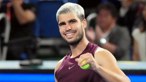 Carlos Alcaraz has a tennis ball in his hand