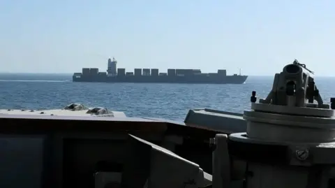 An image of a cargo ship from the guided missile destroyer USS Spruance