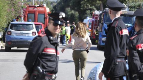 A relatives of a victim arrives as firefighters, medical staff and investigators work at the site of a workplace accident in Casteldaccia, near Palermo, Sicily island, southern Italy, 06 May 2024