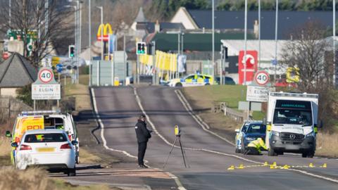 Police carry out investigations on a damaged ambulance 