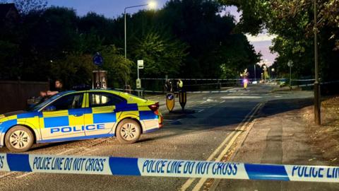 Police cordon with police vehicle in background on Strasbourg Drive