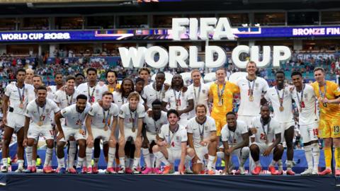 England players pose with their bronze medals after beating France