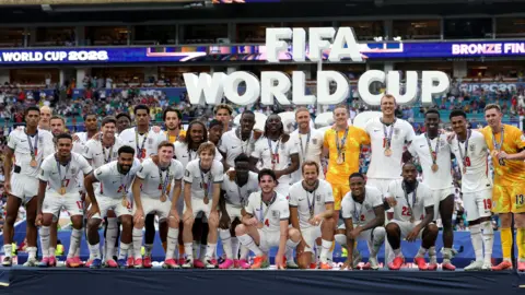 England players pose with their bronze medals after beating France