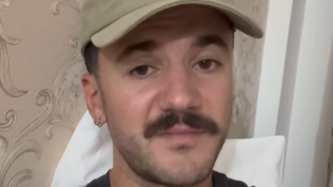 Screengrab of Luke Tarrant, with moustache and baseball cap, looking at the camera.