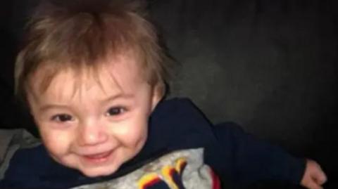 A little boy smiling at the camera