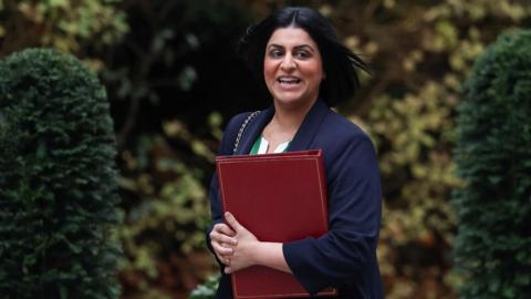 Home Secretary Shabana Mahmood walks outside Downing Street with a red binder