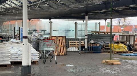 a photo of Skegness Railway station with piles of concrete bags and large sacks of sand