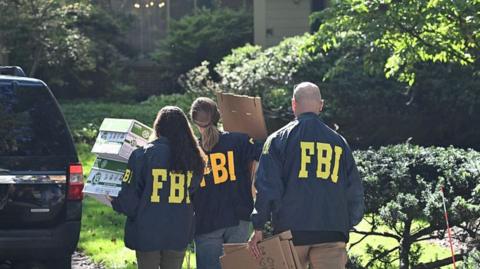 FBI agents at the door of the home of John Bolton