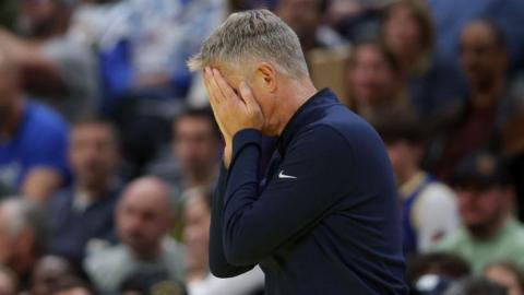 Steve Kerr with his head in his hands.