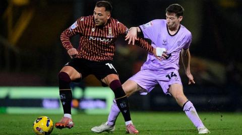 Antoni Sarcevic of Bradford City and Conor McGrandles of Lincoln City