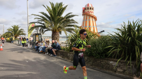 Generic picture of a man running along the beachfront, taken at last years Ironman event in Weymouth.
