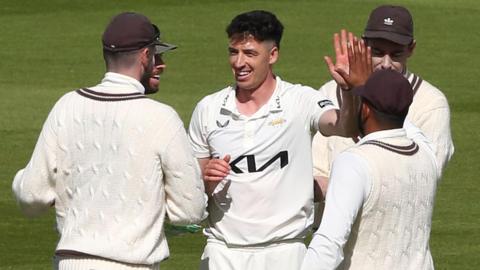 Matt Fisher takes a wicket for Surrey