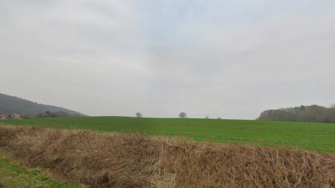 A large grassy field is pictured.