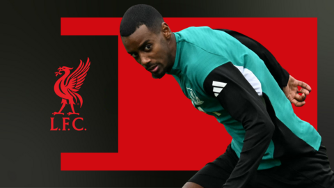 Alexander Isak, wearing Liverpool training gear, in front of a red and black background and the club badge