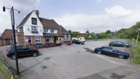 A general view of a pub with a car park.