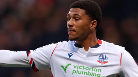 Mason Burstow in action for Bolton Wanderers in their white home shirt