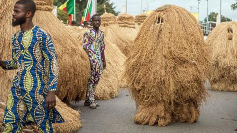 Zangbeto masks parade during the grand procession of traditional masks in Porto-Novo, Benin - 4 August 2024. 