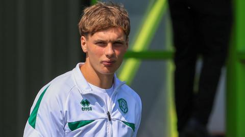 Ben Wodskou watches on during a break in a pre-match warm-up for Yeovil Town. He is wearing the club training zipper.