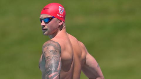 Adam Peaty looks over his shoulder during a training session