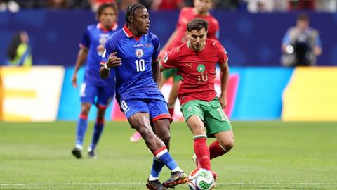 Jean-Ricner Bellegarde of Haiti passes the ball under pressure from Brahim Diaz of Morocco during the FIFA World Cup 2026 Group C match between Morocco and Haiti